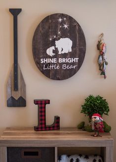 a wooden sign that says shine bright little bear on the wall next to a shelf