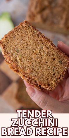 a hand holding up a piece of bread with the words tender zucchini bread recipe