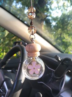 a car dashboard with a flower hanging from it