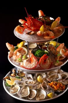 three tiered trays filled with different types of seafood on top of each other