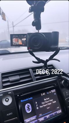 a car dashboard with a dash camera attached to it