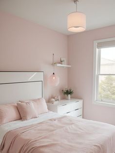 a bedroom with pink walls and white furniture