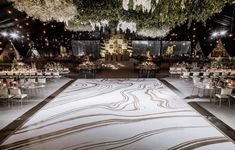 an elegantly decorated wedding reception with white and black decor on the dancefloor