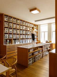 a room filled with lots of wooden shelves