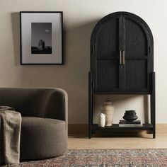 a living room with a couch, chair and book shelf