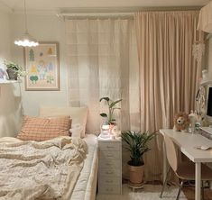 a bedroom with a bed, desk and computer on top of the dresser next to it