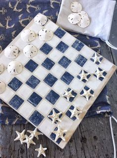 an old chess board with buttons on it and some other items laying around the board