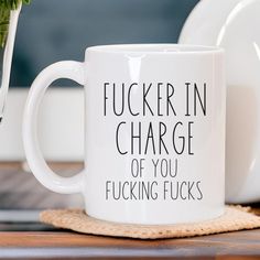 a white coffee mug sitting on top of a wooden table