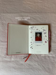 an open notebook with a photo on the cover