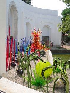 colorful glass sculptures in front of a white building