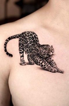 a black and white tattoo of a leopard on the chest