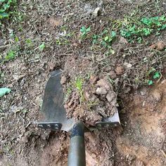 a shovel is stuck in the ground with dirt