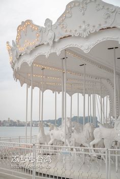 a white merry go round with lights on it