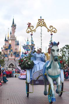 there is a horse drawn carriage with people riding on it in front of the castle