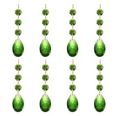 a set of six green glass drops with gold strings hanging from the top and bottom