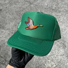 Introducing our laid-back essential, a green 5-Panel High Crown Mesh Back Trucker Hat - the epitome of casual comfort and easygoing style. Crafted for leisurely days, this hat features a high crown design and breathable mesh panels, making it your effortless go-to for a relaxed vibe. What sets this cap apart? A personalized ironed Duck patch on the front. Add a touch of uniqueness that reflects your individuality and style. Whether you're strolling through the city or embracing the great outdoors, the 5-Panel High Crown Mesh Back Trucker Hat keeps you cool and fashionable. Would you like to customize your now hat/patch? Just reach out. Green Trucker Snapback Hat With Flat Bill, Trendy Green Snapback Hat For Summer, Green Flat Brim Hat, One Size Fits Most, Green Summer Trucker Hat With Flat Brim, Green Trucker Hat For Spring, One Size Fits Most, Green Summer Trucker Hat, Green Flat Brim Trucker Hat For Summer, Green Spring Trucker Hat, Green Flat Brim Baseball Cap For Summer