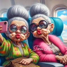 two older women sitting on an airplane seat taking a selfie with their cell phone