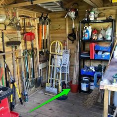 the inside of a shed with various tools and cleaning supplies on shelves, including brooms