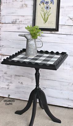 a black and white checkered table with a vase on it