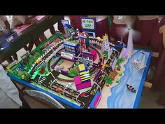 a child playing with a toy train set on top of a table in a room