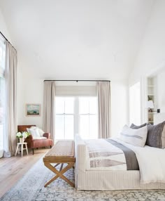 a bed room with a neatly made bed next to a window