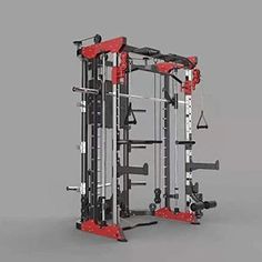 a red and black gym machine sitting on top of a white floor next to a gray wall