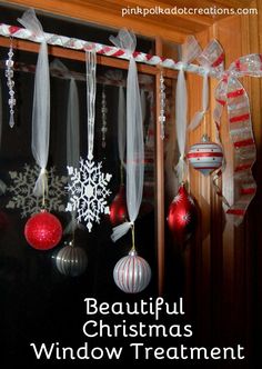 beautiful christmas window treatment with ribbon and ornaments hanging from the windowsill in red, white and silver