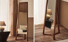 a mirror sitting on top of a wooden floor next to a lamp