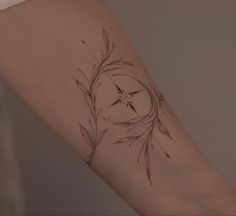 a woman's arm with a tattoo on it that has an image of a flower in the center