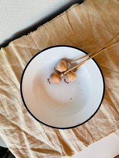 a white plate with some food on it and two chopsticks in the middle