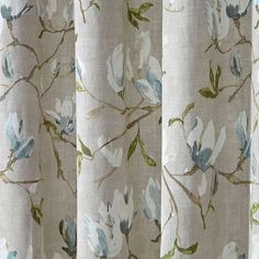 a close up view of a curtain with flowers and leaves printed on it in beige