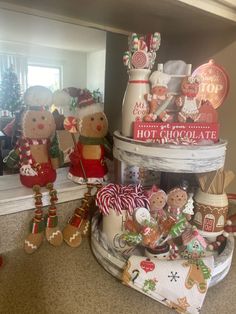 several christmas decorations are stacked on top of each other in front of a mirror and window