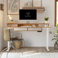 a desk with a computer on top of it in front of a wall mounted screen