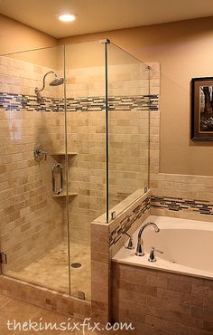 a bath tub sitting next to a walk in shower