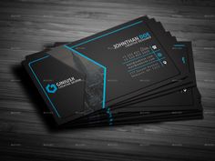 four black and blue business cards sitting on top of a wooden table