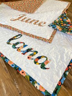 two quilts are laying on top of each other with the word love spelled out