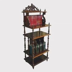 an old wooden shelf with many books on it