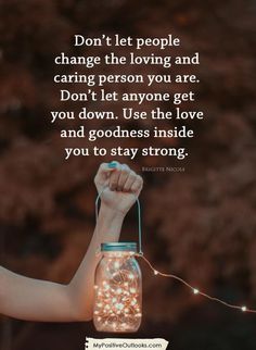 a person holding a mason jar with lights in it and the words don't let people change the loving and caring person you are