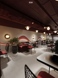 the interior of a restaurant with red chairs and black tables, potted plants on either side