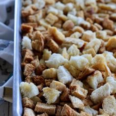 a baking pan filled with bread crumbs sitting on top of a table