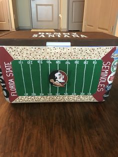 the florida state university football stadium cooler is sitting on the floor in front of an open door