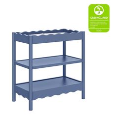 a blue shelf with scalloped shelves on the bottom, and greenguard stickers above it