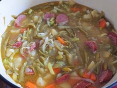 a pot filled with soup and meat on top of a stove