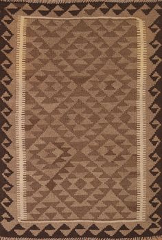 a brown and white area rug with an intricate design