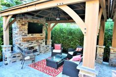 an outdoor living area with patio furniture and fireplace