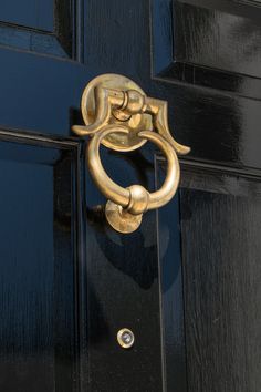 a black door with a gold handle on it