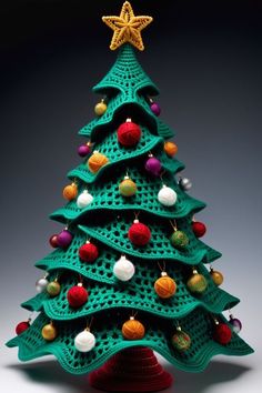 a crocheted christmas tree with ornaments on it