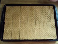 a pan filled with crackers on top of a wooden table