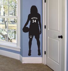 a wall decal of a female basketball player with the number 34 painted on it