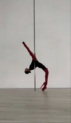 a person doing a handstand on a pole